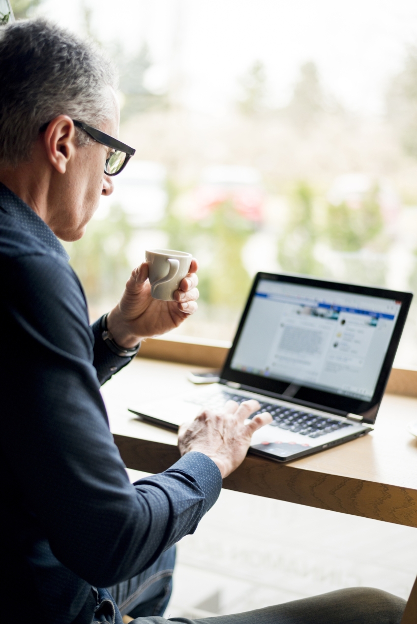 Elderly businessman working laptop